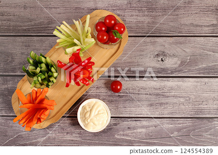 Raw food concept and diet food, vegetable sticks in glass cups and sauce for weight loss, intermittent fasting. Healthy breakfast with ingredients, menu for cafe or restaurant, kitchen background, 124554389