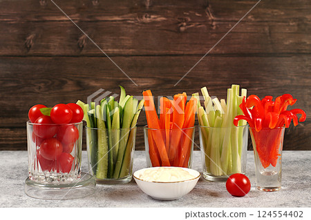 Vegetable sticks in glass cups and sauce for weight loss, intermittent fasting. Raw food concept and diet food, Healthy breakfast with ingredients, menu for cafe or restaurant, kitchen background, 124554402