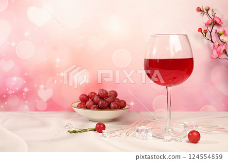 Modern still life with glass of red wine, orange slices, ice and grapes on elegant background with sakura flowers, minimalist bar and summer party concept, advertising banner and menu for cafe 124554859