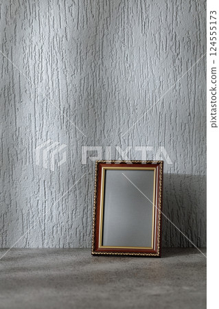 Empty picture frame on a gray background. Empty picture frame on a gray background. 124555173