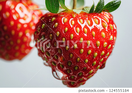 Fresh strawberry splashing in clear water background with vibrant juicy details. A vivid strawberry splashing into water, showcasing freshness and vitality. Summer, vitamins, healthy eating theme 124555184