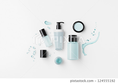 Assorted cosmetic containers on white background with product and packaging variety. A flat lay of various cosmetics and textures on a clean background. Men's cosmetics 124555192