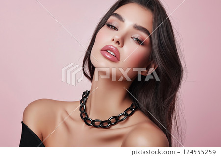 A close-up of a young woman confidently wearing bold black chain necklace showcasing modern and stylish fashion, striking features with elegance and charm. Studio fashion shot 124555259
