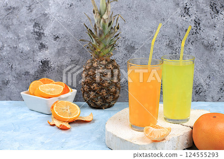 Detox diet and summer party concept. Cold homemade cocktail or lemonade with rosemary, orange, ice and pineapple, Refreshing summer diet drink recipe, restaurant menu, selective approach. 124555293
