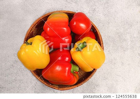Sweet bell peppers and tomatoes on concrete table. Various ripe red and yellow fruits for healthy vegetarian food and detox diet, harvest. Advertisement of shop and market Sweet bell peppers and tomatoes on concrete table. Various ripe red and yellow fruits for healthy vegetarian food and detox diet, harvest. Advertisement of shop and market 124555638