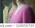 closeup of colorful woolen pullover on hangers in a woman fashion store showroom 124555735