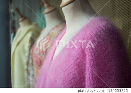 closeup of colorful woolen pullover on hangers in a woman fashion store showroom 124555735