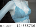 Closeup of blue bra on mannequin in a fashion store showroom 124555736