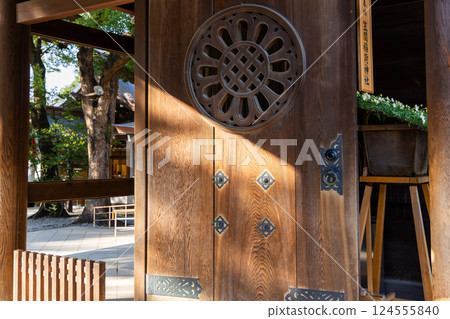 Wooden gate Meiji Shrine in Tokyo features an intricate circular carving with symmetrical patterns Wooden gate Meiji Shrine in Tokyo features an intricate circular carving with symmetrical patterns 124555840