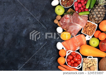 Healthy balanced food with dietary ingredients, vegetables, fruits, nuts, meat, fish for weight loss, healthy lifestyle concept, place for text, selective focus Healthy balanced food with dietary ingredients, vegetables, fruits, nuts, meat, fish for weight loss, healthy lifestyle concept, place for text, selective focus 124555897