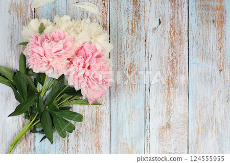 Bouquet of delicate flowers peonies, roses on a sunny table for a gift to loved ones. Spring still life and banner for the screen, elegant beauty concept, template for design. Abstract flower Bouquet of delicate flowers peonies, roses on a sunny table for a gift to loved ones. Spring still life and banner for the screen, elegant beauty concept, template for design. Abstract flower 124555955