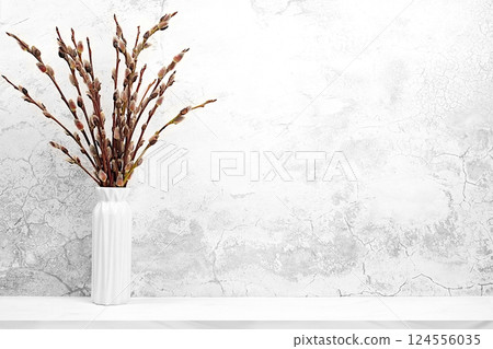 Delicate pussy willow flowers in vase on grey background, abstract spring floral arrangement. Easter card and still life, minimal holiday concept, religious banner, home interior, selective focus 124556035
