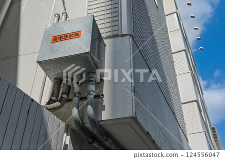 Voltage equipment installed on the exterior wall of a building 124556047