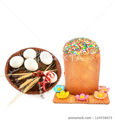 Easter eggs in a wicker basket and Easter cake isolated on a white background. 124556073