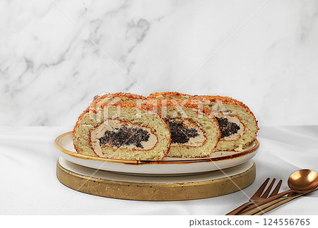 Homemade delicious dessert, biscuit or roll with sweet jam, cream, nuts and cinnamon filling. Modern bakery concept, festive treat and advertising for cafe and restaurant, selective focus 124556765