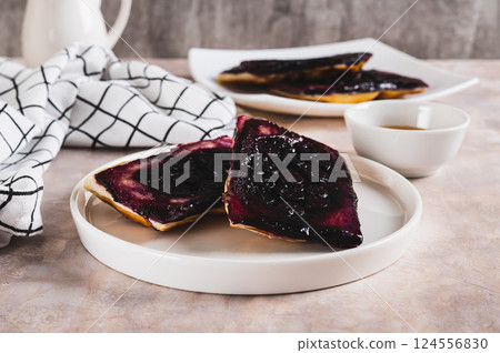 Blueberry upside down pies on a plate on a table Blueberry upside down pies on a plate on a table 124556830