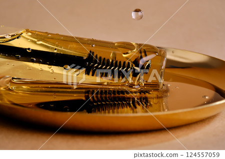 Bottle with brush filled with oil for eyebrow and eyelash growth. Texture. 124557059