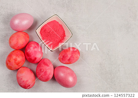 Easter celebration concept, marble Easter eggs painted with pink matcha on concrete background with sakura branches, ideas for homemade Easter dishes. Easter celebration concept, marble Easter eggs painted with pink matcha on concrete background with sakura branches, ideas for homemade Easter dishes. 124557322