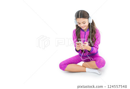teen girl with music playlist in studio, banner. teen girl choose music playlist on background. teen girl with music playlist in studio, banner. teen girl choose music playlist on background. 124557548