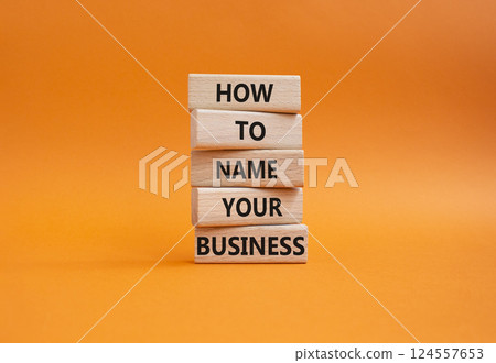 Business symbol. Wooden blocks with words How to name your Business. Beautiful orange background. Business How to name your Business concept. Copy space. Business symbol. Wooden blocks with words How to name your Business. Beautiful orange background. Business How to name your Business concept. Copy space. 124557653