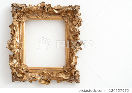 Golden frame in Baroque style with detailed carvings isolated on white background. Ornate golden frame with intricate details for art display. Mockup, empty space for text or image 124557973