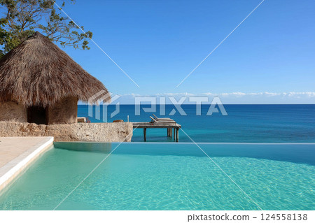 Thatched-roof cabana by an infinity pool overlooking a serene ocean. A tranquil scene featuring a cabana with thatched roof near a luxurious pool. Summer vacation concept, warm summer vibes Thatched-roof cabana by an infinity pool overlooking a serene ocean. A tranquil scene featuring a cabana with thatched roof near a luxurious pool. Summer vacation concept, warm summer vibes 124558138