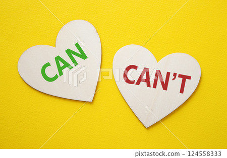 Can or Cant symbol. Concept word Can or Cant on wooden hearts. Beautiful yellow background. Business and Can or Cant concept. Copy space 124558333