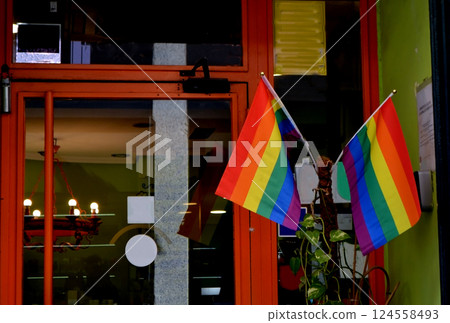 Vibrant lgbt flags displayed outside colorful storefront. Madrid, Spain Vibrant lgbt flags displayed outside colorful storefront. Madrid, Spain 124558493