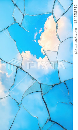 Cracked glass window reflecting bright blue sky and storm clouds in stunning detail Cracked glass window reflecting bright blue sky and storm clouds in stunning detail 124558712