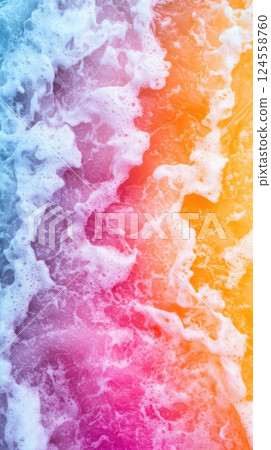 Waves sparkle with neon colors on serene beach under daylight while freezing on the other side 124558760