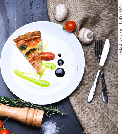 Piece of pizza on grey texture background. Homemade cuisine 124559346