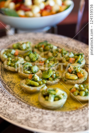 A plate of traditional Turkish artichoke dish, cooked with olive oil and vegetables, served in a plate, showcasing fresh and healthy Mediterranean flavors. 124559556