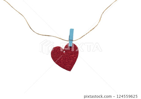 Paper heart with glitter hanging on a rope with a clothespin. Heart isolated on white background Paper heart with glitter hanging on a rope with a clothespin. Heart isolated on white background 124559625