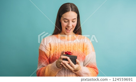 Woman excitedly receiving a gift box present Woman excitedly receiving a gift box present 124559691