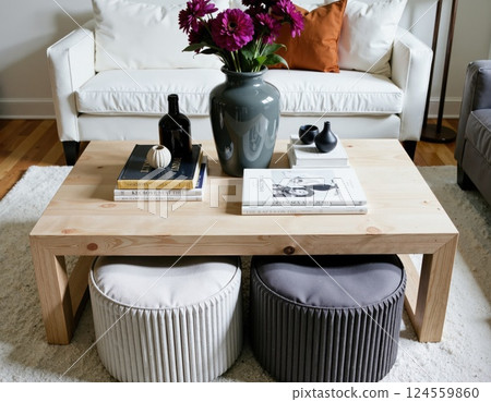 Cozy modern living room with floral decor and minimalist coffee table design 124559860