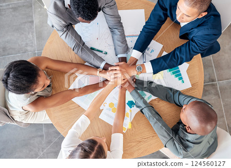 Hands, teamwork and motivation with a business team sitting at a table in a boardroom from above. Collaboration, meeting and unity with an employee group working on finance or accounting documents 124560127