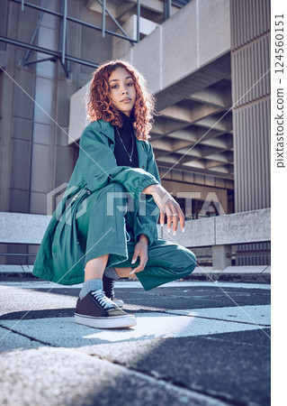 Trendy, style and cool teenage girl portrait in an urban city alone. Fashion, street style and young woman on an edgy day outside. Town, clothing and fashionable lady in summer 124560151