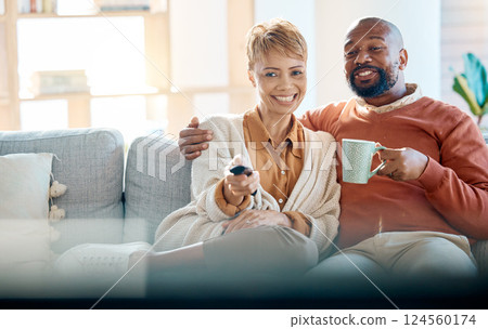 Watching tv, home and couple relax together on sofa or home living room for online show, movie or comedy. Love, care and black woman, man or happy people streaming film on television for quality time 124560174