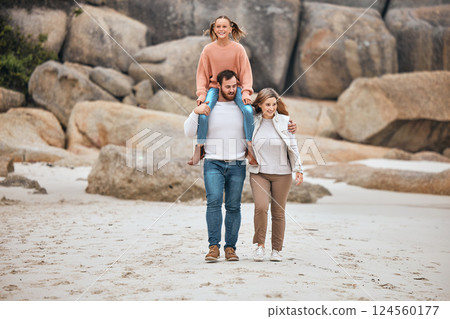 Family, beach and travel with child, mom and dad walking together for adventure, vacation and bonding time in nature. Man and woman parents with girl by sea for happiness, fitness and outdoor fun 124560177