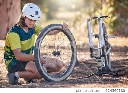 Mountain bike cycling, tire repair and man check, fix or does maintenance on broken or damaged bicycle wheel. Fitness workout, training exercise and adventure man fixing travel bike in nature forest Mountain bike cycling, tire repair and man check, fix or does maintenance on broken or damaged bicycle wheel. Fitness workout, training exercise and adventure man fixing travel bike in nature forest 124560180