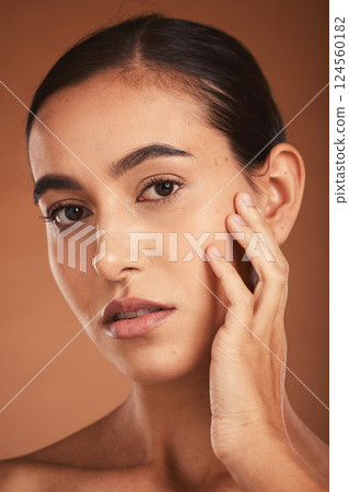 Skincare, young girl and face with cosmetics, confident and healthy organic facial with brown studio background. Portrait, makeup and girl with pride, natural beauty for smooth skin and wellness. 124560182