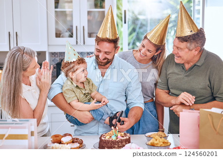 Happy family, cake and happy birthday for a child at a party with a big family in a lovely celebration at home. Excited grandparents, mother and father celebrate a young kids birthday party together 124560201