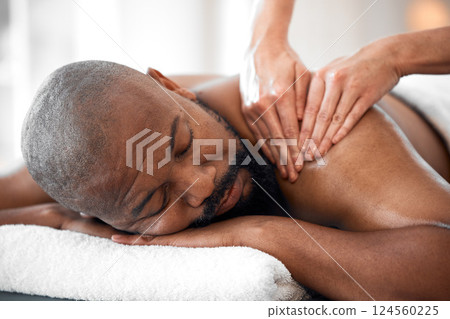 Relax man, spa and back massage for luxury wellness, therapy, healing and skincare. Therapist touch body, muscle and reflexology of sleeping black man on salon bed, stress relief and holistic detox 124560225