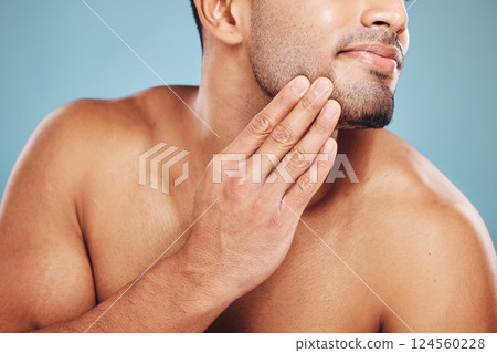 Man, beard care and hands on face after grooming, fresh and clean shave isolated on blue studio background. Beauty, skincare and wellness of male model, good facial hygiene routine and healthy skin. 124560228