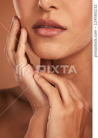 Beauty, skincare and lips, portrait of woman in studio, luxury spa treatment for healthy and glowing skin, cropped. Health, wellness and model girl with beautiful face and mouth on brown background. Beauty, skincare and lips, portrait of woman in studio, luxury spa treatment for healthy and glowing skin, cropped. Health, wellness and model girl with beautiful face and mouth on brown background. 124560232