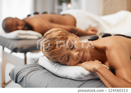 Spa, couple and hot stone massage in wellness, health and beauty salon for pamper, stress relief and pamper treatment. Spa massage, woman and man relax with peace, zen and rock luxury treatment Spa, couple and hot stone massage in wellness, health and beauty salon for pamper, stress relief and pamper treatment. Spa massage, woman and man relax with peace, zen and rock luxury treatment 124560313
