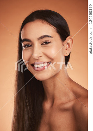 Cosmetics, skincare and young woman with natural beauty, confident and pride with brown studio background. Portrait, makeup and girl smile face, wellness and organic facial for glow skin and pride. 124560359