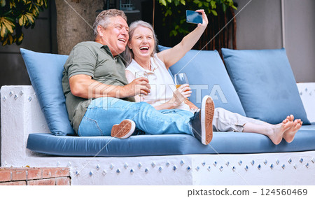 Selfie, relax and senior couple with a drink on an outdoor sofa on holiday in Costa Rica. Retirement, alcohol and happy elderly man and woman with a phone for photo, smile and memory on a vacation 124560469