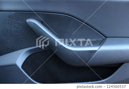 Handle and pocket on the inner panel of a car door Handle and pocket on the inner panel of a car door 124560537