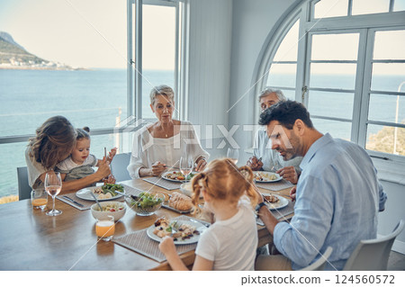 Family, generations and food, eating together in family home by the beach, healthy meal, nutrition and bonding. Big family, parents with grandparents and children eat at house by coast of Australia. 124560572